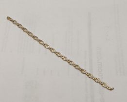 A 9ct gold and diamond infinity loop bracelet total weight 4.6g Location: