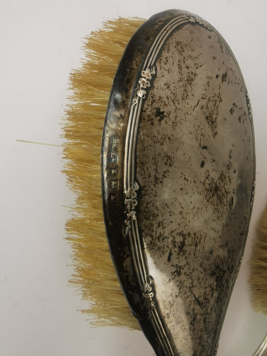 Three dressing table hair brushes to include silver brushes and a white metal embossed hair brush - Image 3 of 4