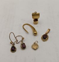 Mixed 9ct gold items comprising of a charm fashioned as a well, garnet set pendant and earrings