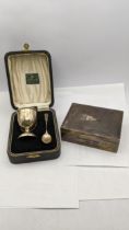 A silver machine turned box along with silver egg cup and spoon in a case Location: