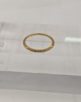 An 18ct gold ring with a band of diamonds Location: