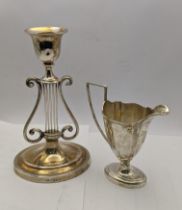 A silver candle stick holder weighted hallmarked London 1902, together with a silver jug 113.1g