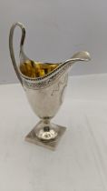 A 20th century silver cream jug in the George III style with bright cut decoration 139.1g Location: