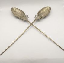 A pair of South American white metal Quchua 'TuPu' shawl pins, having engraved floral design,