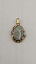 A 15ct gold pendant set with a large oval opal and diamonds, 5.1g Location: