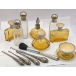 Dressing table items to include brown glass bottles with engine turned lids, silver handled manicure