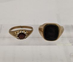 A 9ct gold signet ring and another set with a garnet 8.5g Location: