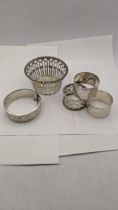 Silver compromising of three napkin rings, a pierced bowl, along with a bracelet having engraved