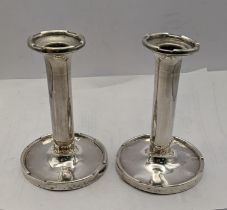 A pair of silver candle stick holders hallmarked Birmingham 1924 Location: