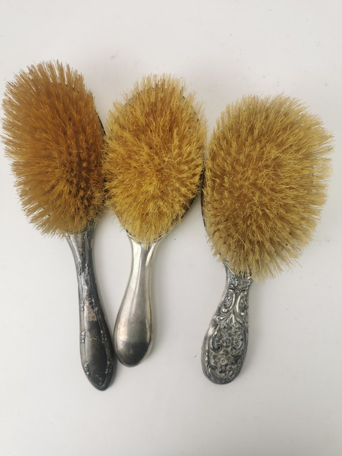 Three dressing table hair brushes to include silver brushes and a white metal embossed hair brush - Image 2 of 4