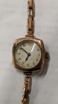 An early 20th century Rotary 9ct gold manual wind wristwatch on a yellow metal expanding bracelet