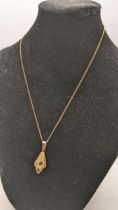 A 9ct gold necklace having a pendant inset with coloured glass stones 3.8g