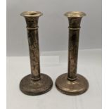 A pair of early 20th century white metal weighted candlestick holders Location: