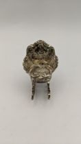 A silver miniature rocking chair stamped 925 having an embossed floral detail, 21.2g, Location: