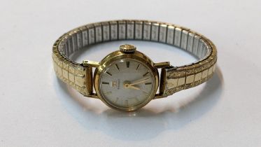 A vintage Tissot 9ct gold manual wind wristwatch on a gold plated expanding bracelet Location: