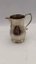 A silver cream jug hallmarked London 1962, total weight 154.5g Location: