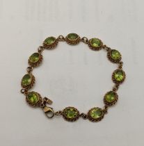 A 9ct gold and peridot bracelet, total weight 10.1g Location: