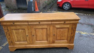 A modern French style oak sideboard with three drawers and three doors, on bracket feet, 198cm long,