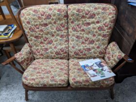 Ercol dark oak cottage three piece suite compromising two seater sofa and two matching armchairs