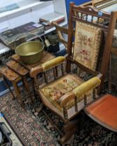 An early 20th century beech framed American rocking chair upholstered in green decorative fabric, an