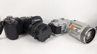 A Sony DSC - F828 digital camera together with a Sony DSC F717 camera with a Carl Zeiss Vario