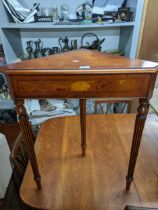 An inlaid burr wood contemporary corner table with inlaid shell motif, on three turned and fluted