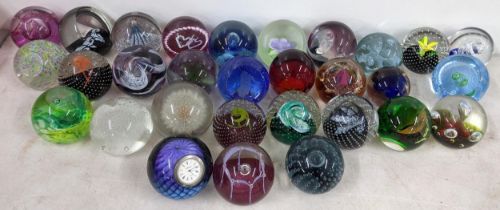 A selection of paperweights to include a Jim Munnelly Whitefriars green swirl paperweight, Caithness