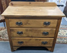 A late Victorian pine chest of three drawers having a raised back and on bracket shaped feet, 89cm h