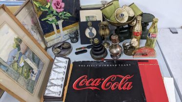 A mixed lot to include a boxed set of name/menu holders, gold coloured Coca Cola bottles, framed