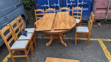 A modern French style oak extending dining table on splayed leg, and eight ladder back chairs
