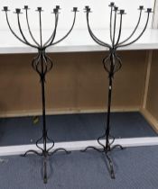 A pair of wrought iron seven branch floor standing candlesticks, 128h Location: