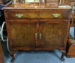 An early 20th century walnut veneered cabinet having a single drawer above two doors 84.5cm h x 84cm