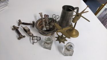 A mixed lot to include candlesnuffer, wine coaster, brass model of a Spitfire, cutlery rests, pair