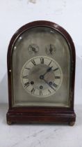 An Edwardian mahogany arched top 8 day mantle clock having subsidiary regulation dial and chime/