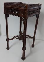 A late 19th/early 20th century mahogany kettle stand in the Chippendale style having pierced