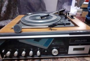 A vintage National Panasonic compact stereo system with teak housed speakers and manual. Location: