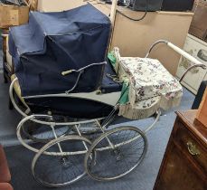 A vintage Silver Cross pram on a white painted frame Location: