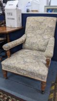 A late Victorian John Reid & Sons deep oak armchair on turned front legs and signed casters