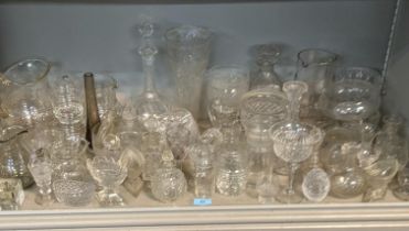 A mixed lot of glassware to include a smoked glass jug, crystal cut decanters, a pair of cube