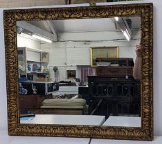 An early 20th century gilt framed wall mirror having sausage and pea decoration and moulded frame