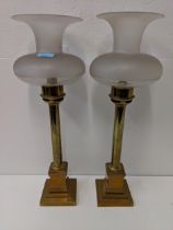 A pair of brass candlesticks lamps with etched glass shades. Location: