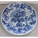 A large Delft blue and white charger decorated with scenes of Oriental figures Location: