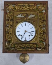 A 19th century German wall hanging clock having an embossed metal face and 8-day movement striking