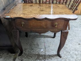 A 19th century oak lowboy with a shaped top, over a drawer, on carved cabriole legs, 75cm x 84cm x