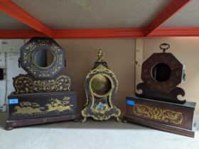 Three ornate European clock cases to include two with inlaid brass work decoration, the other a