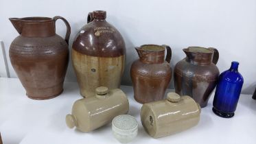 A mixed lot to include a Jones & Rye Witney salt glazed flagon, two footwarmer, a Chiltern Hills