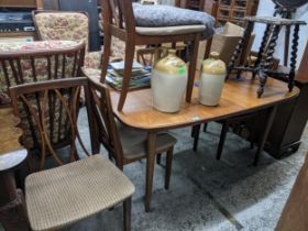 A 1970s G-Plan teak extending dining table 73cm x 143cm (unextended) x 99cm, and a matching set of