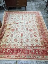 A contemporary hand woven Afghan Zeigler rug, all over floral design in red and blue, on a sandy