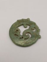 A jade double sided carved disc fashioned as a dragon, Location: