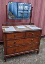 An early 20th century mahogany dressing chest of four drawers with swing mirror above, 145cm h x